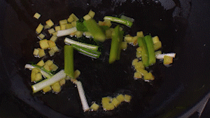鍋中熱油，依次下姜粒、蔥段、蘆筍炒香。
