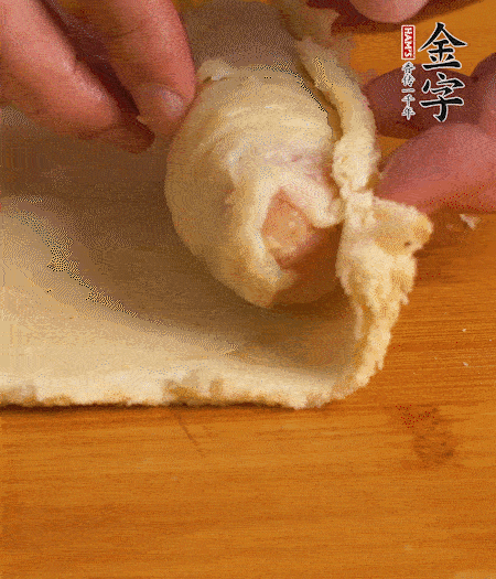 吐司卷起香腸，吐司尾端涂抹少許全蛋液，卷好的吐司表面蘸上蛋液，在裹上一層面包糠，送入預(yù)熱好的烤箱中。