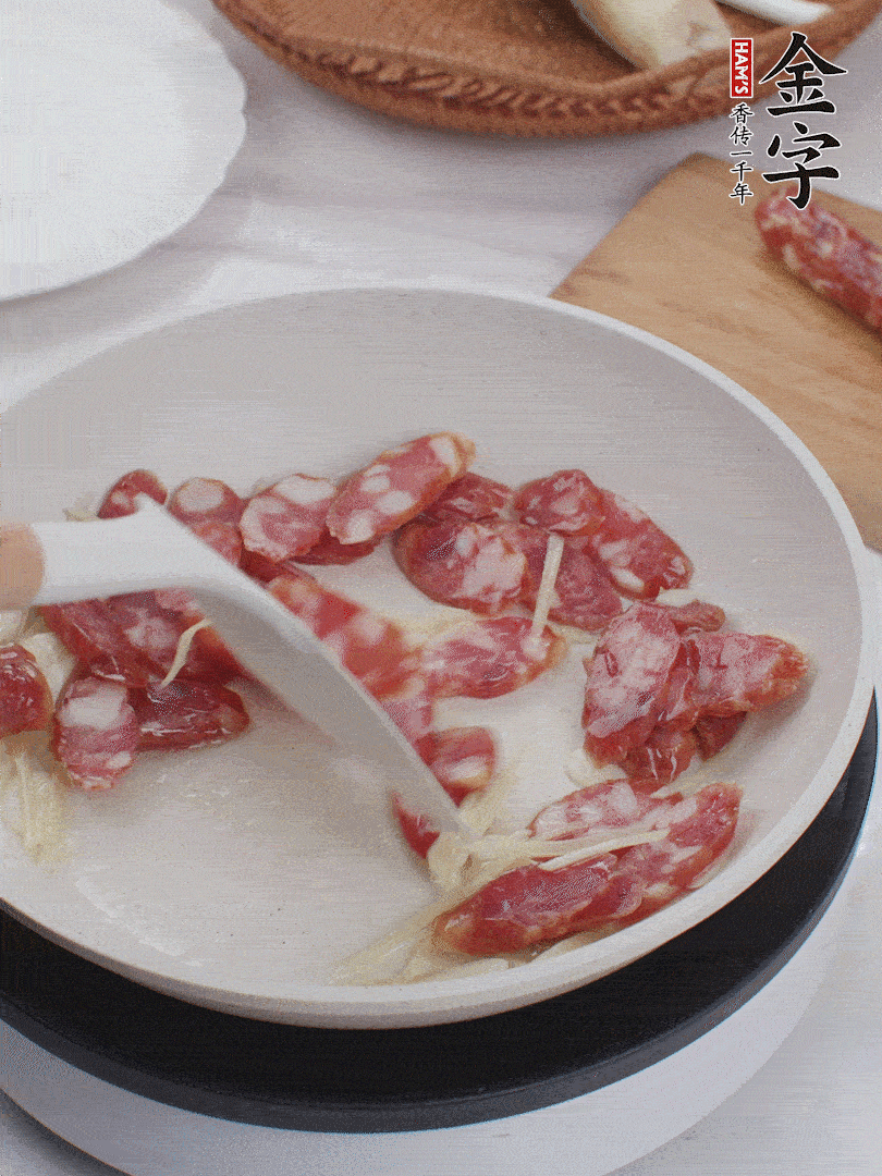 油溫3成熱時，下姜絲、蒜片、香腸炒出油脂。