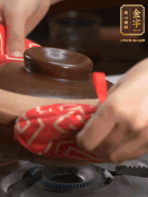 中火調(diào)成小火，鋪上香腸蓋蓋燜5分鐘。不斷轉(zhuǎn)動瓦煲，讓側(cè)壁的飯形成飯焦